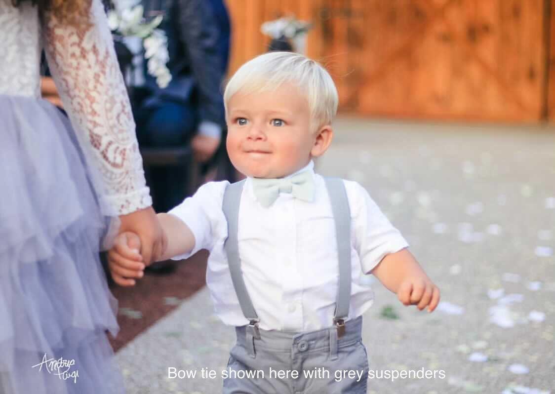 Toddler bow tie in sage green worn by a ring bearer.