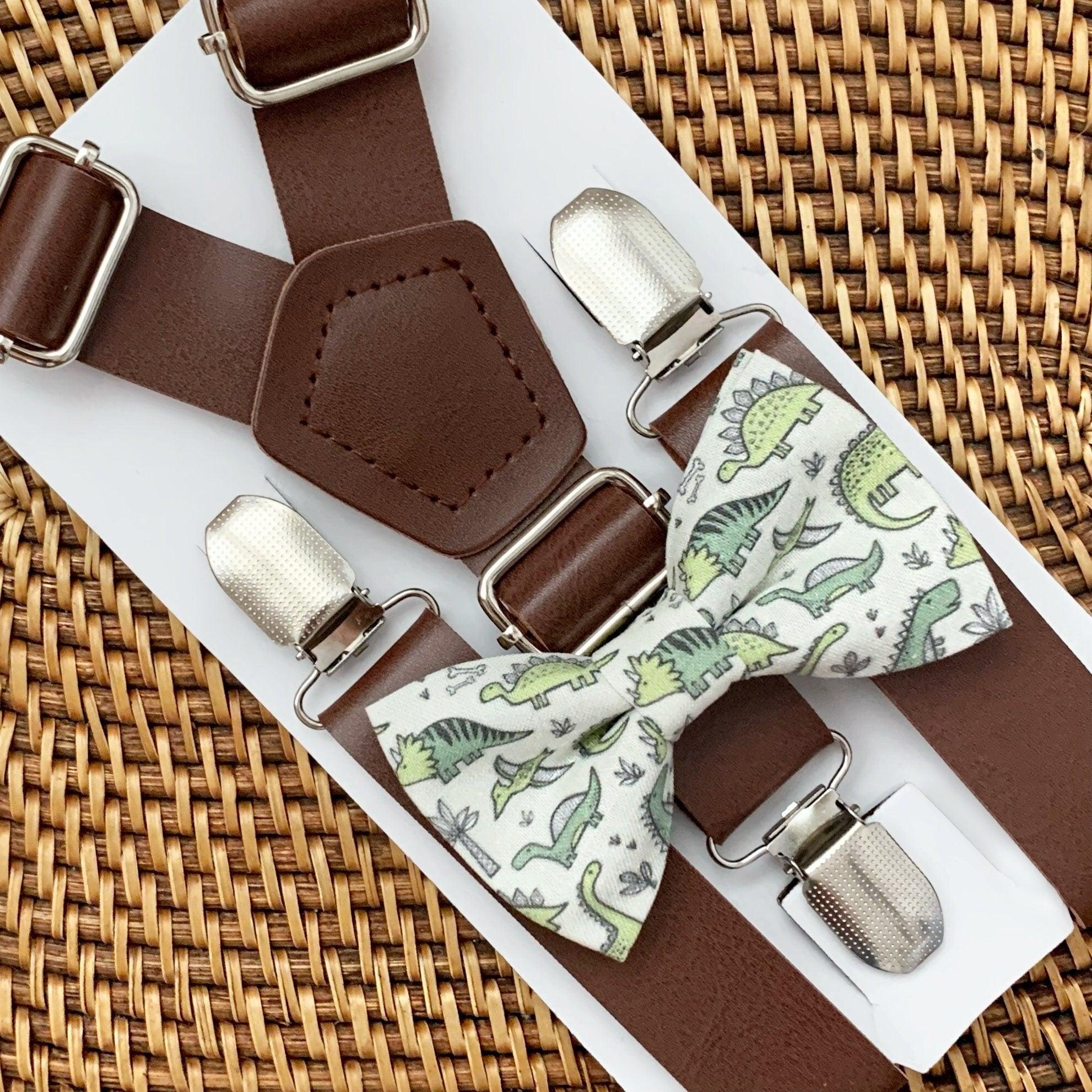 Brown vegan suspenders with metal clips and a green dinosaur print fabric as part of a bow tie set.