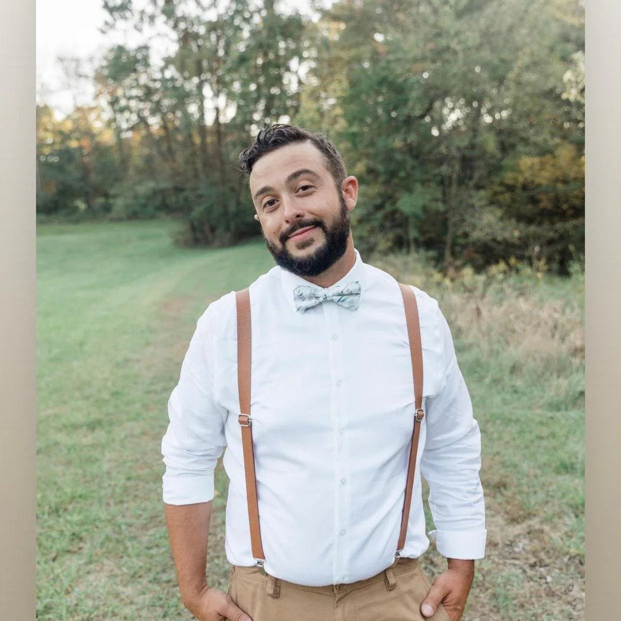 Groom waiting for his bride in brown vegan leather suspenders and sage floral bow tie.