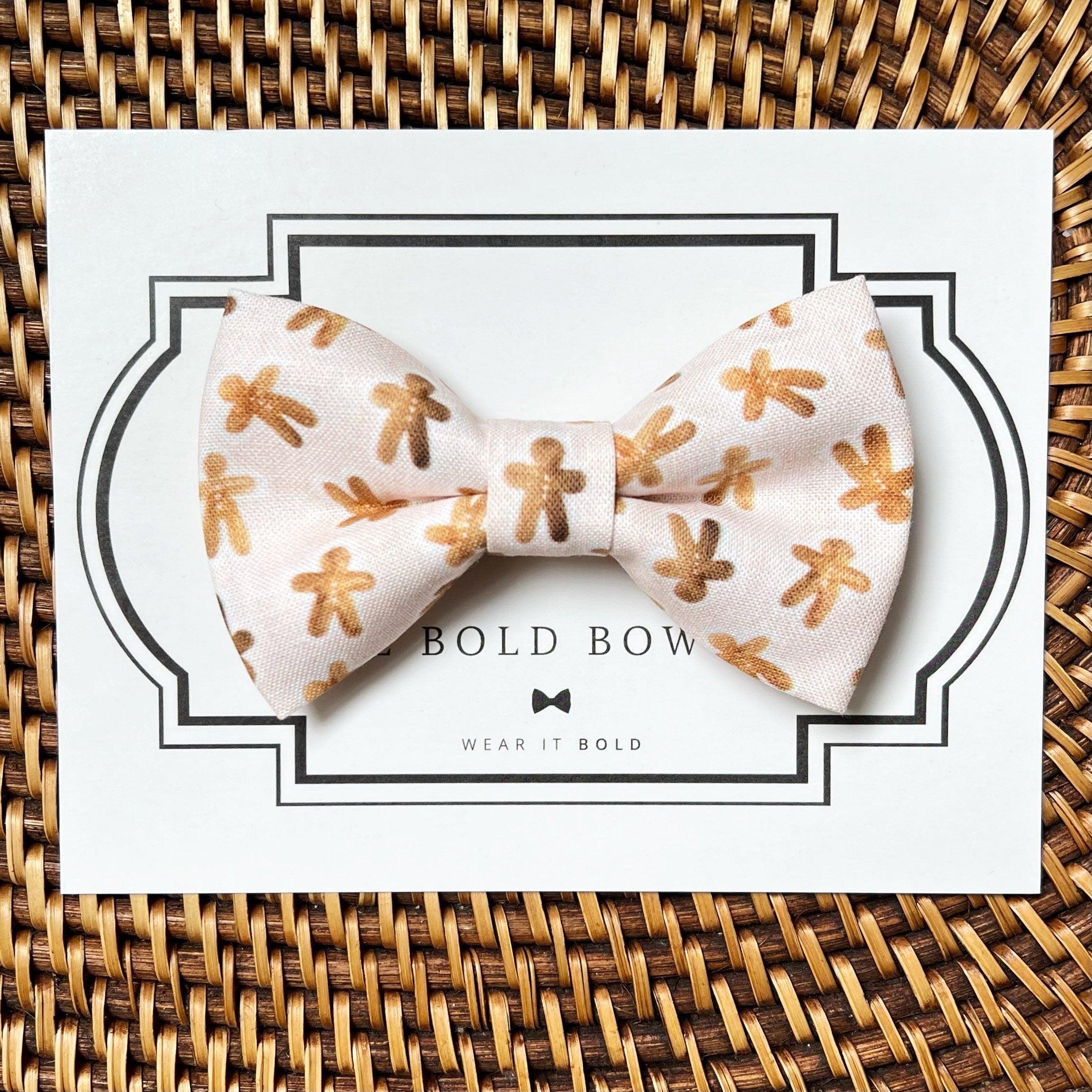 Gingerbread man patterned bow tie for dog or cat collars displayed on a card