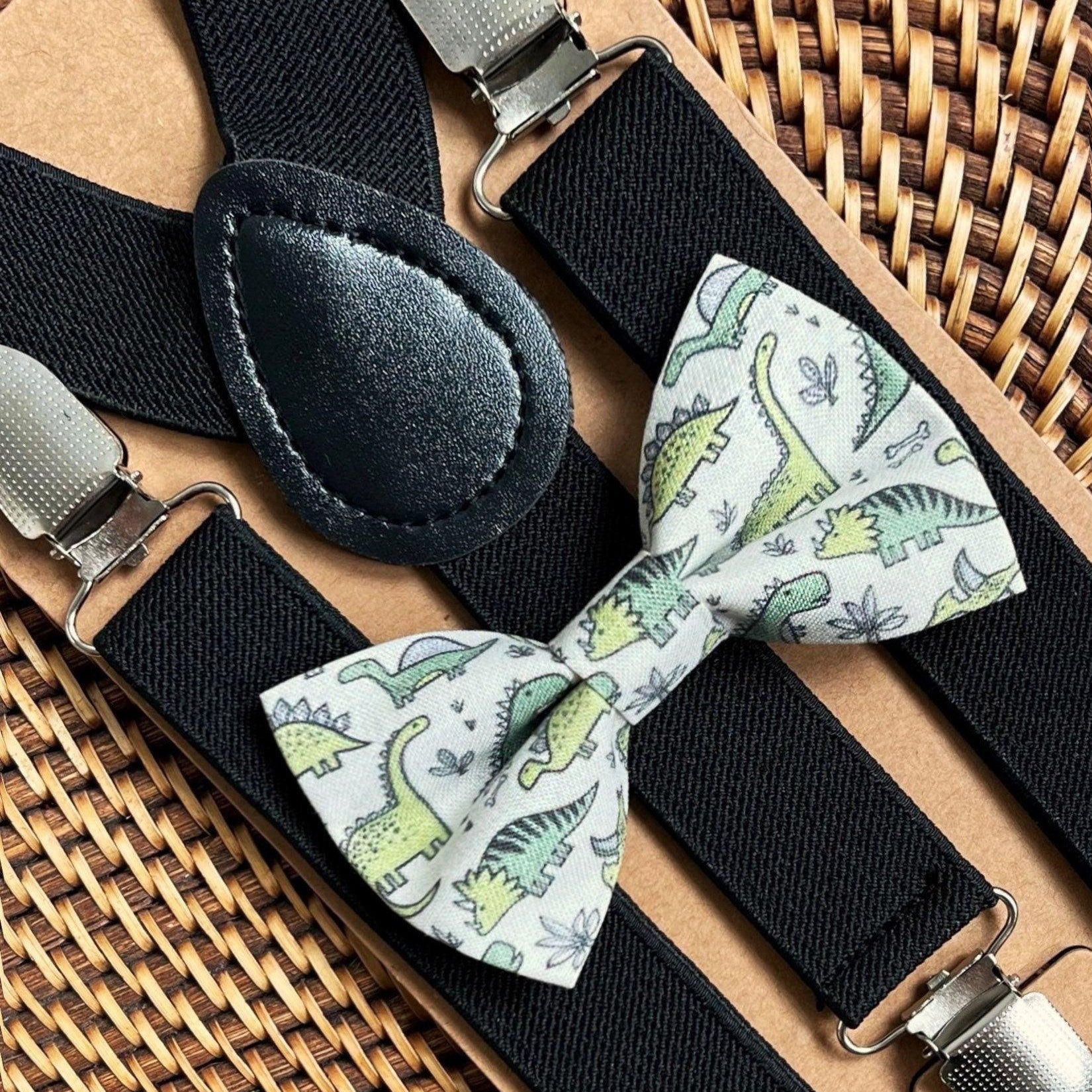 Dinosaur print bow tie with green dinosaurs and black elastic suspenders with metal clips