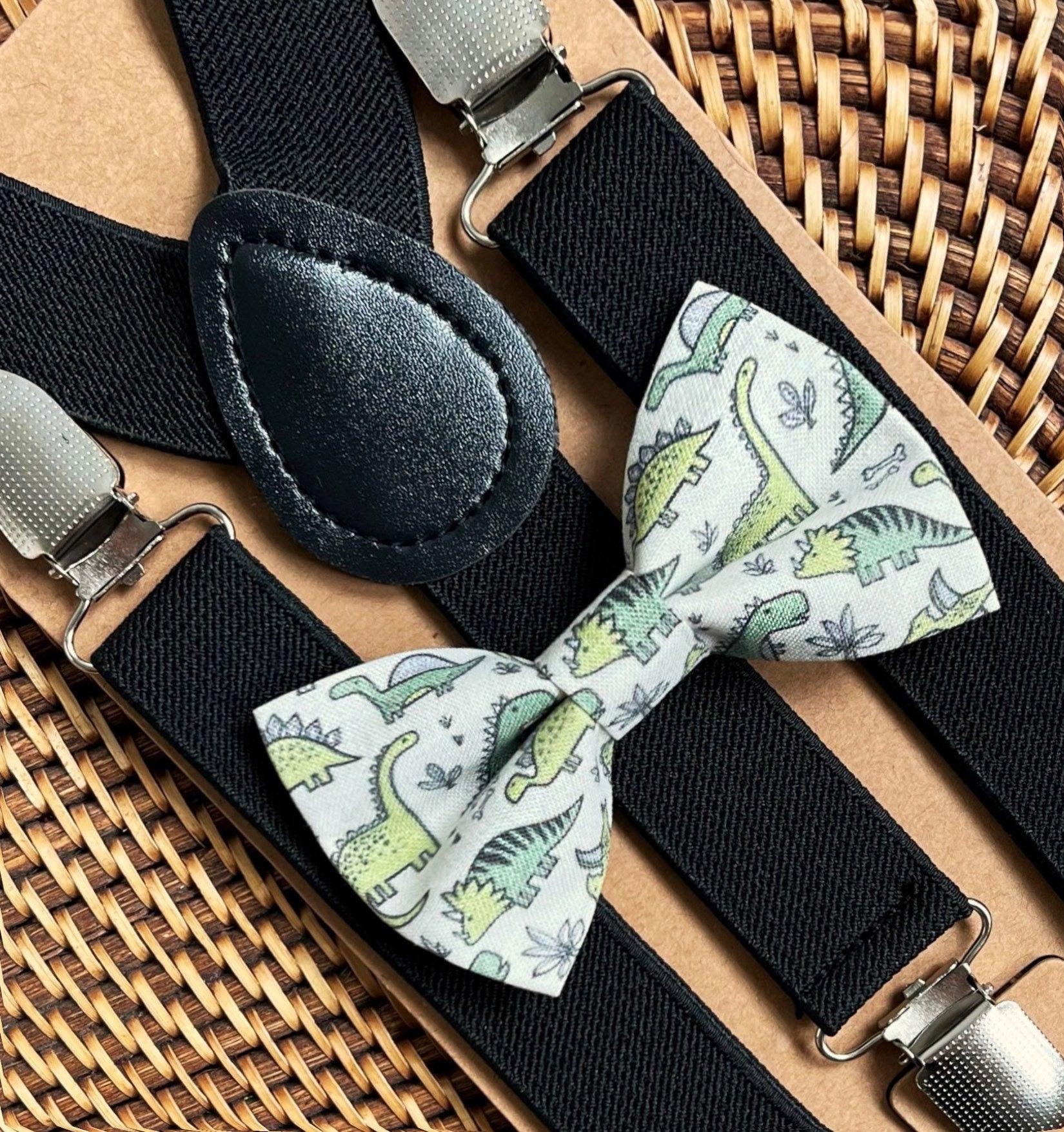 Dinosaur print bow tie with green dinosaurs and black elastic suspenders with metal clips