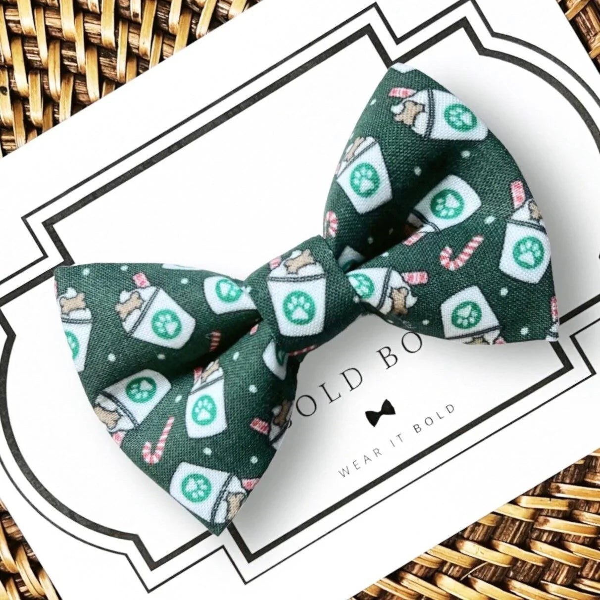 Green festive dog bow tie with a printed pattern mounted on a white card for collar use