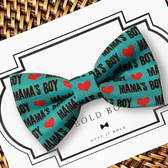 Teal dog bow tie with Mama's Boy pattern and red hearts displayed on a card