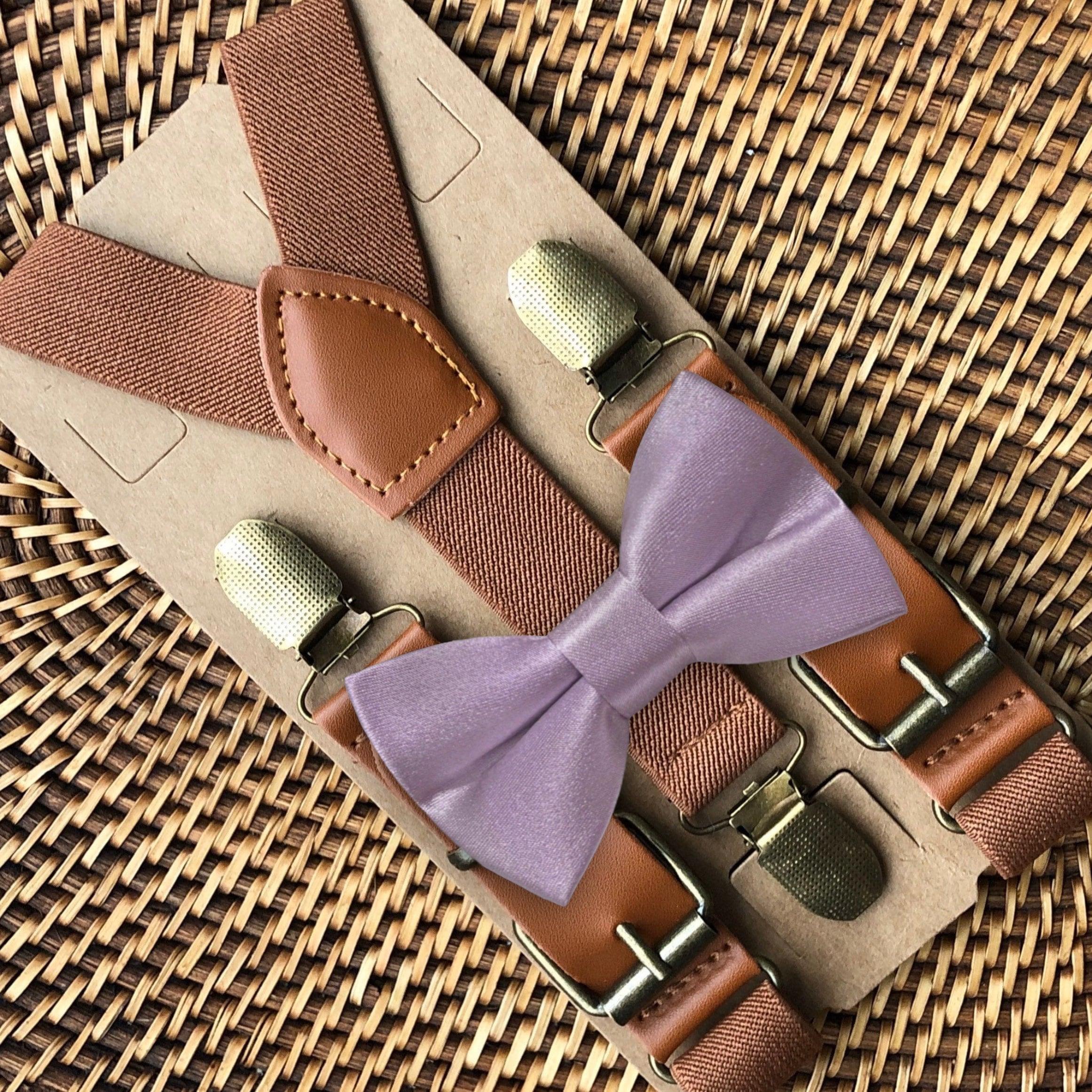 Lavender bow tie with brown cognac leather suspenders and metal clip hardware displayed on kraft backing