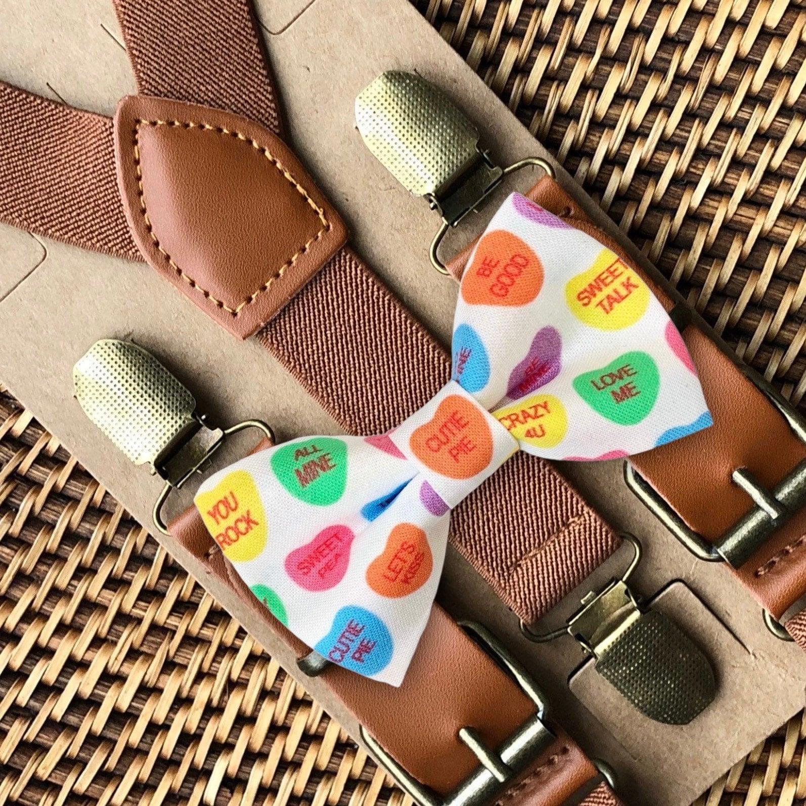Valentine bow tie with multicolor heart print paired with cognac buckle suspenders on brown leather