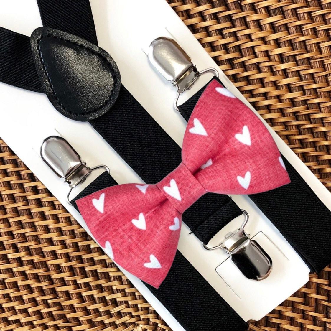 Red hearts bow tie paired with black elastic suspenders on a white display card