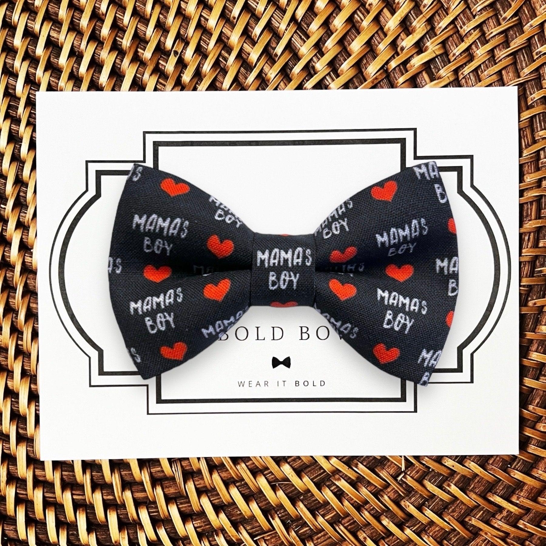 Back side of red and black buffalo plaid dog bow tie for collars on a wooden surface.