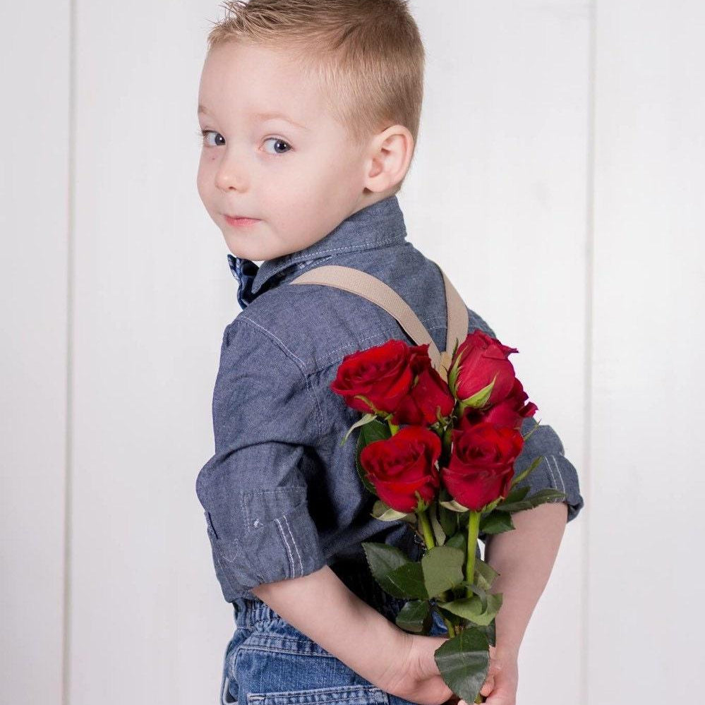 Ring bearer in tan suspenders