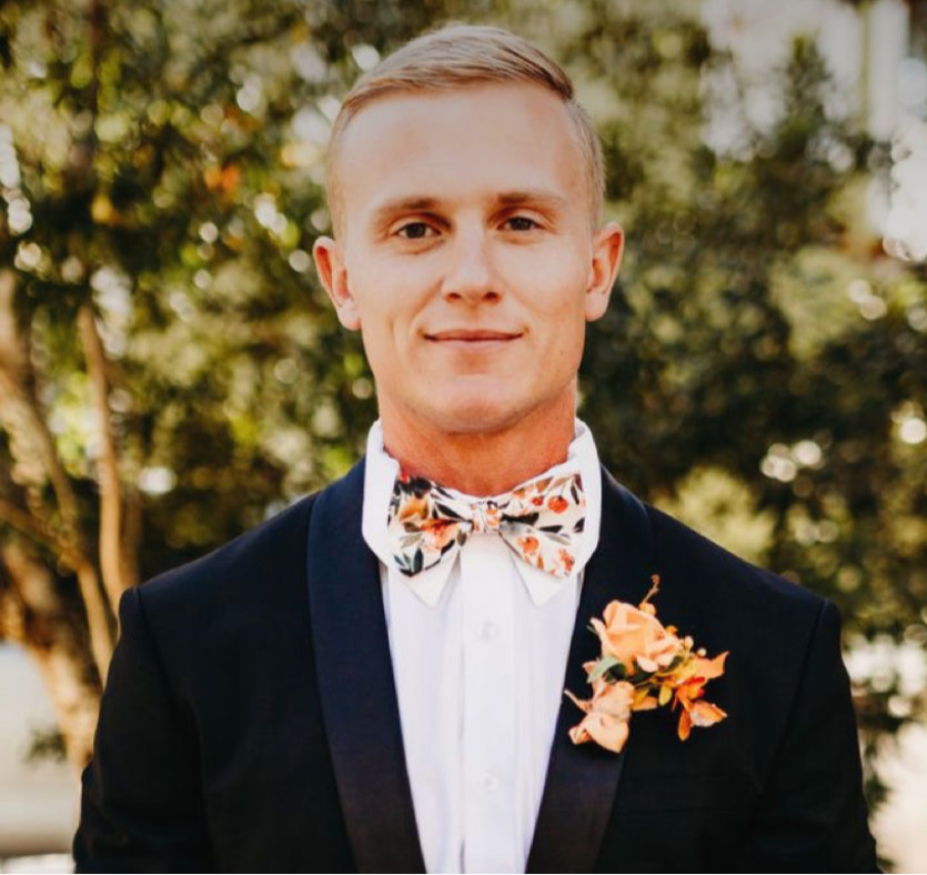 Groom wearing an ivory terracotta floral bow tie.