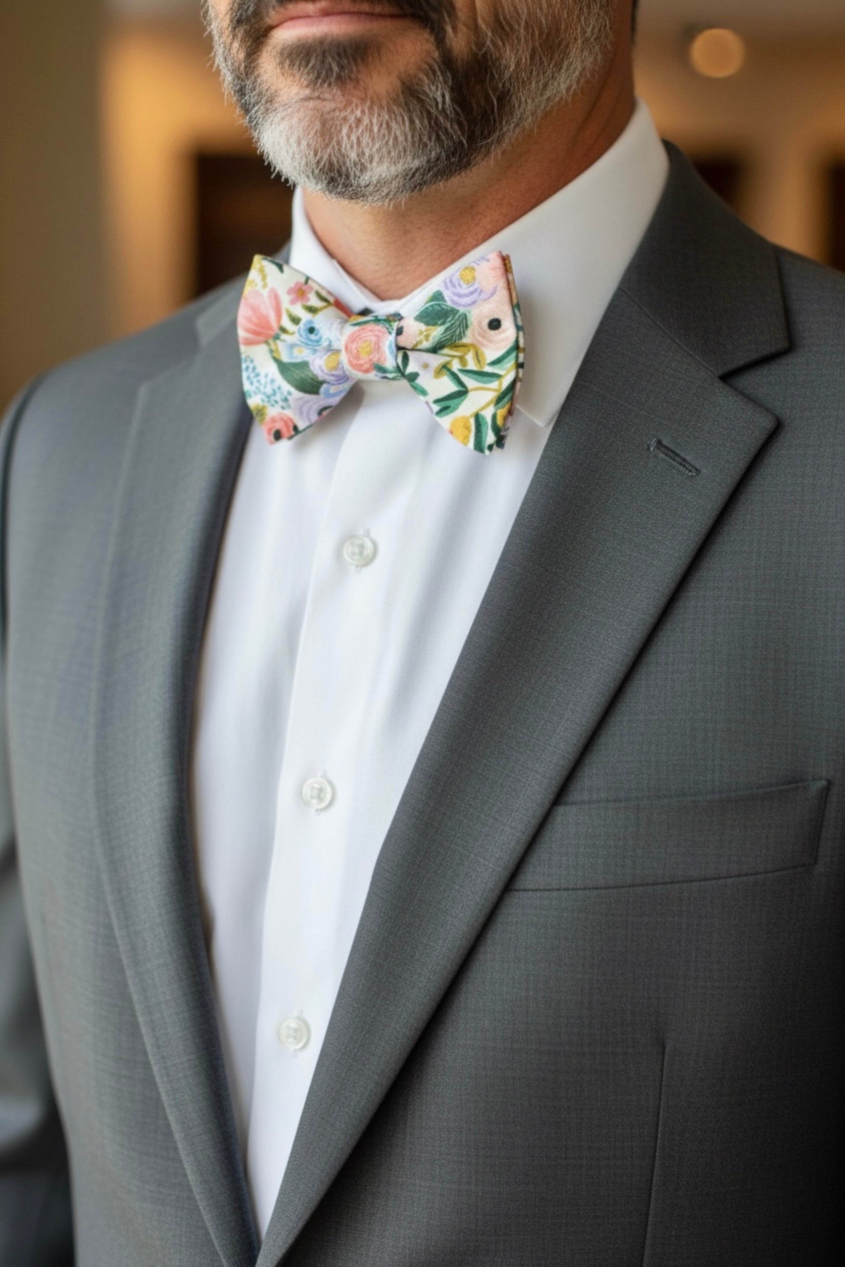 Texture detail of a white cotton floral bow tie featuring high-quality botanical print fabric.