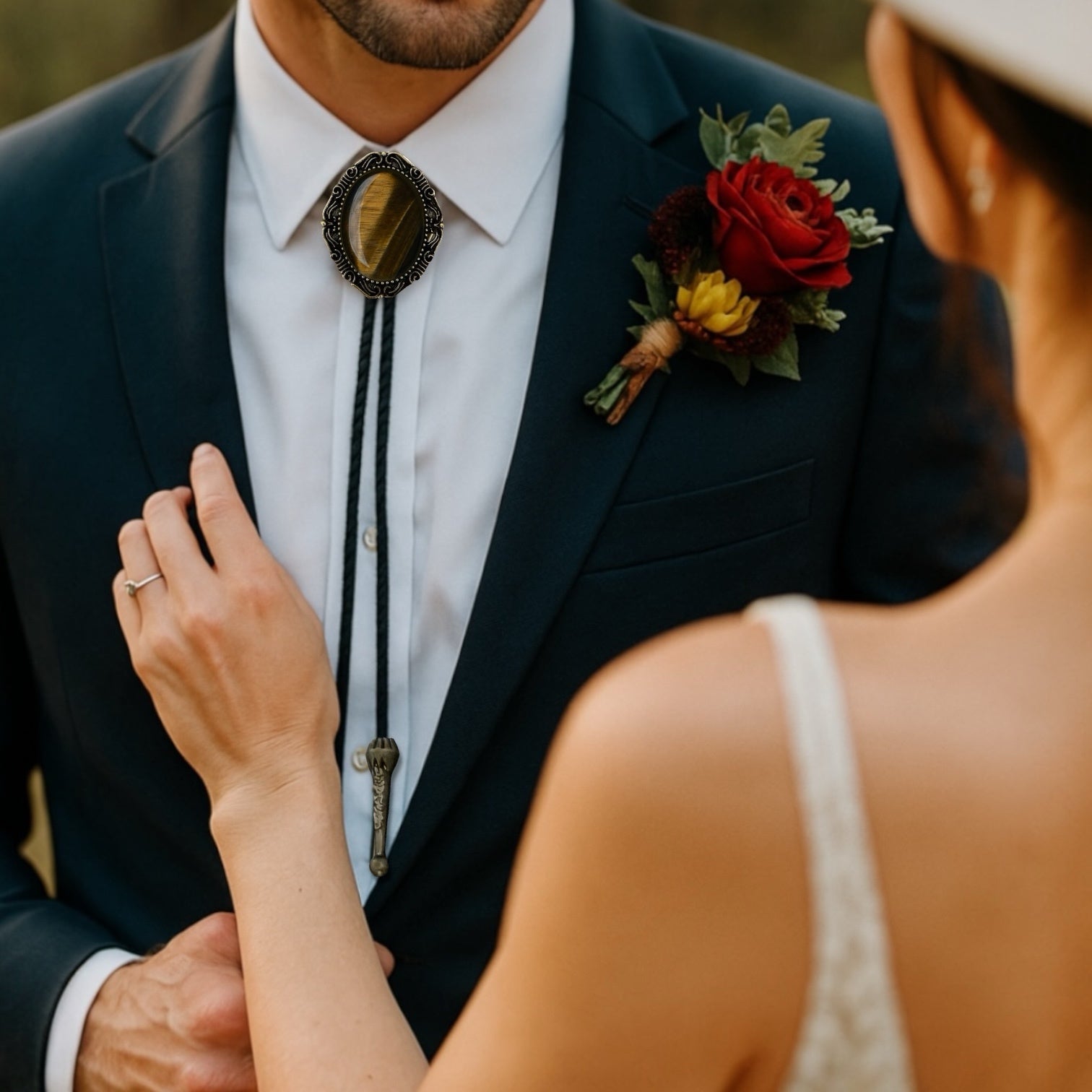 Men’s bolo tie being worn by a groomsman at a wedding.