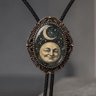 Celestial bolo tie with leather cord.