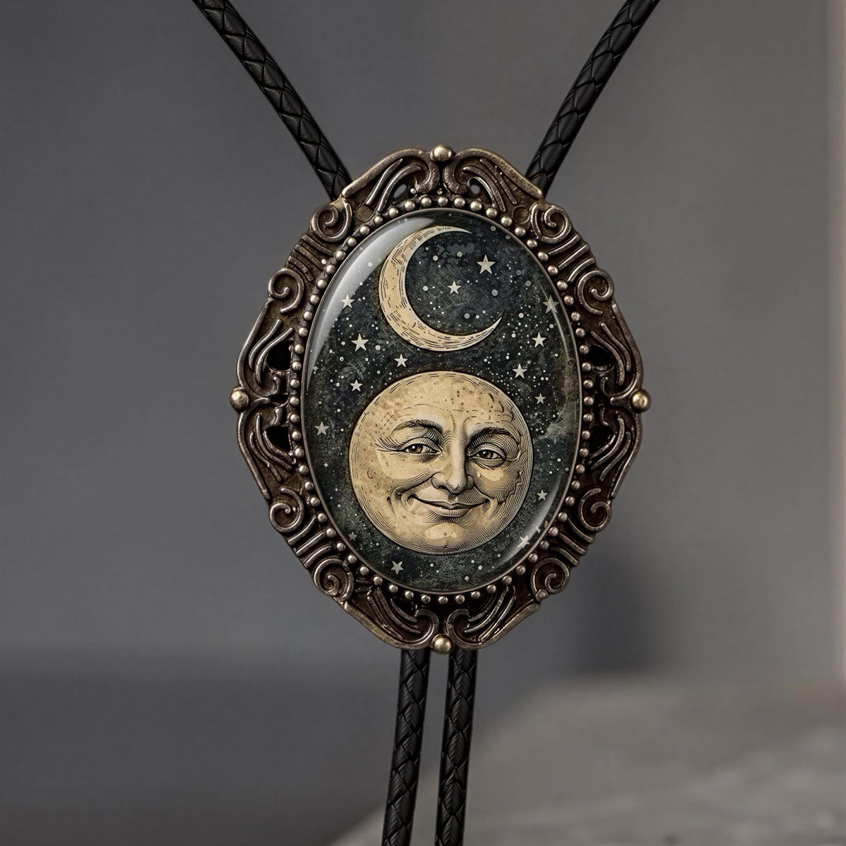 Celestial bolo tie with leather cord.