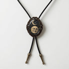 A decorative necklace with a pendant featuring a moon and crescent symbol, possibly representing the moon and the crescent moon.