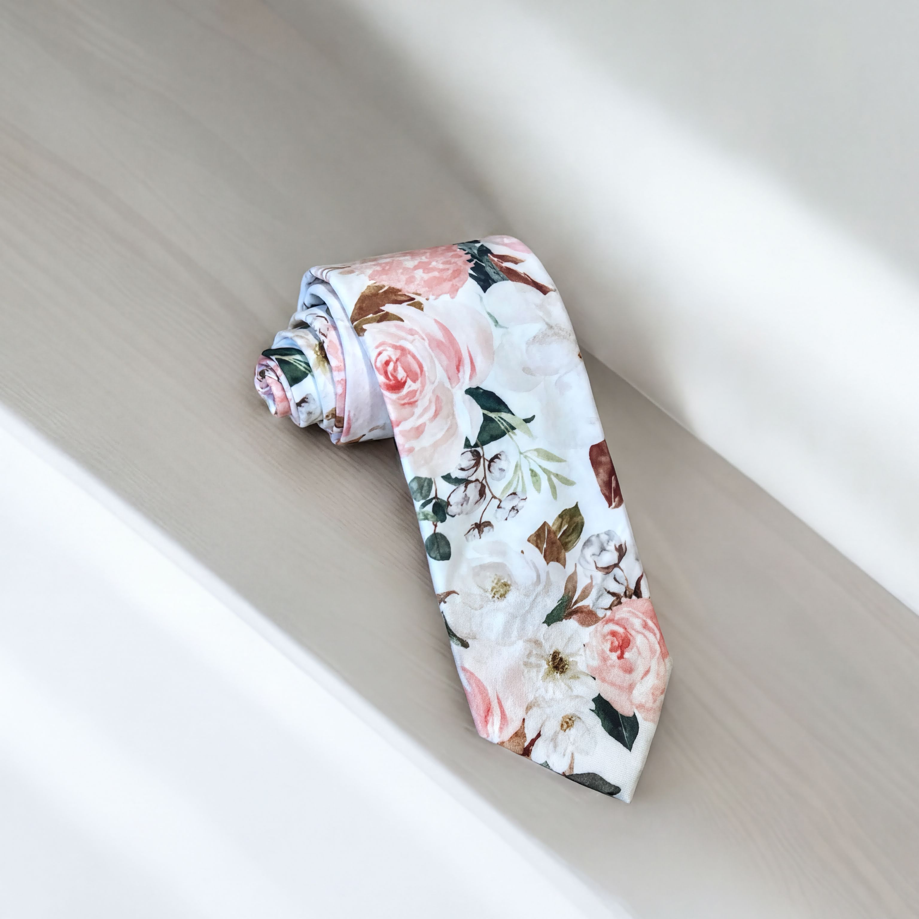 Blush and white floral men’s tie for wedding or special event.