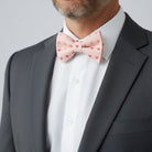 Valentines Day bow tie worn by a man in a suit.