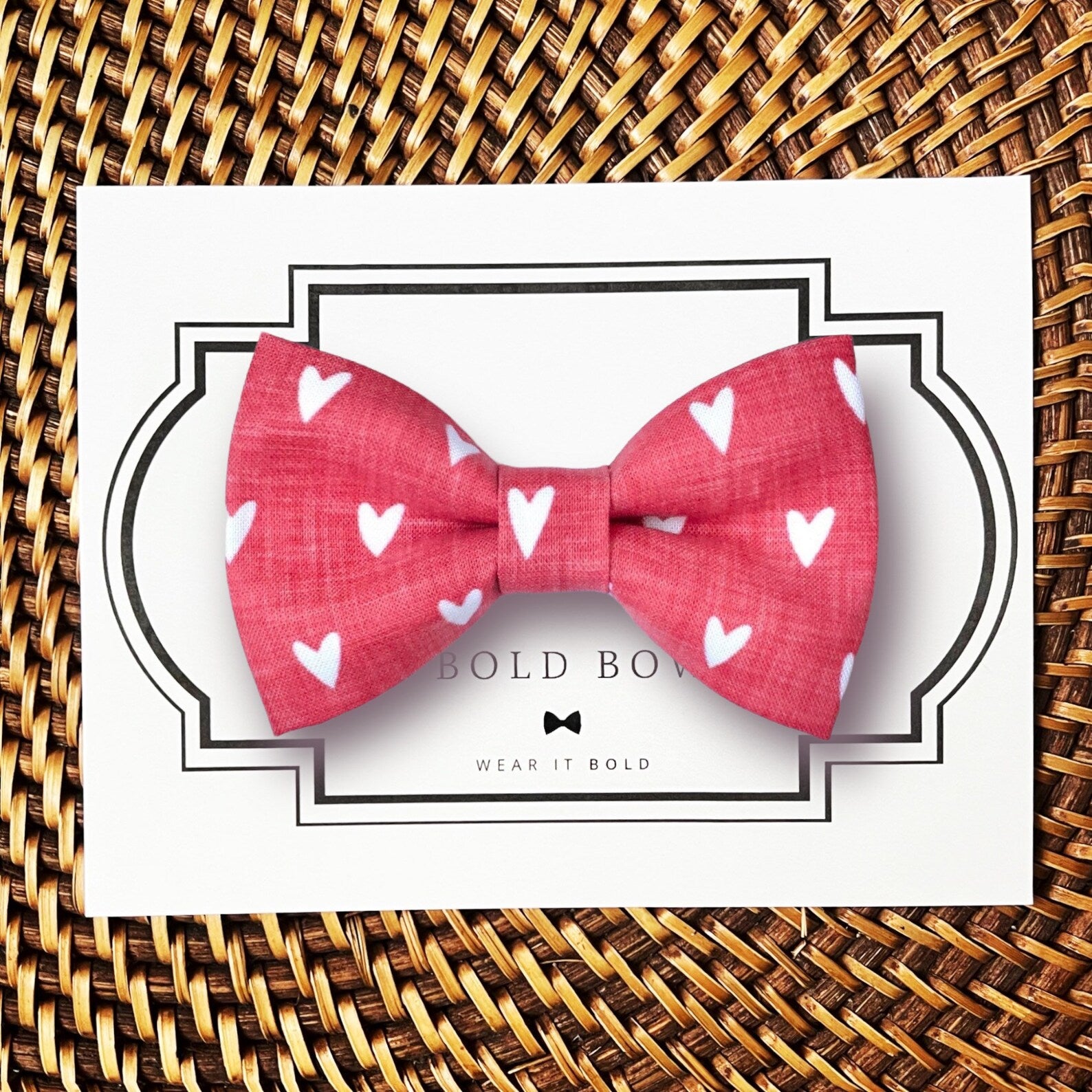 a red bow tie with white hearts on it
