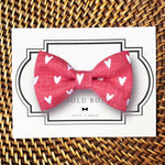 Load image into Gallery viewer, a red bow tie with white hearts on it
