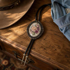 A decorative floral pendant necklace with a wooden drawer and a denim jacket are visible in the image.