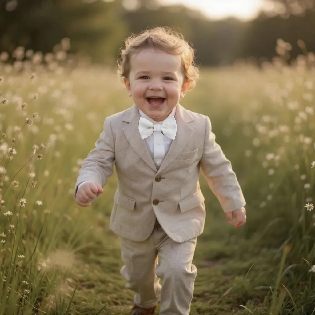 Ring bearer wearing a white bow tie for wedding