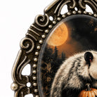 a close-up of a decorative metal frame with a large, full moon in the background.