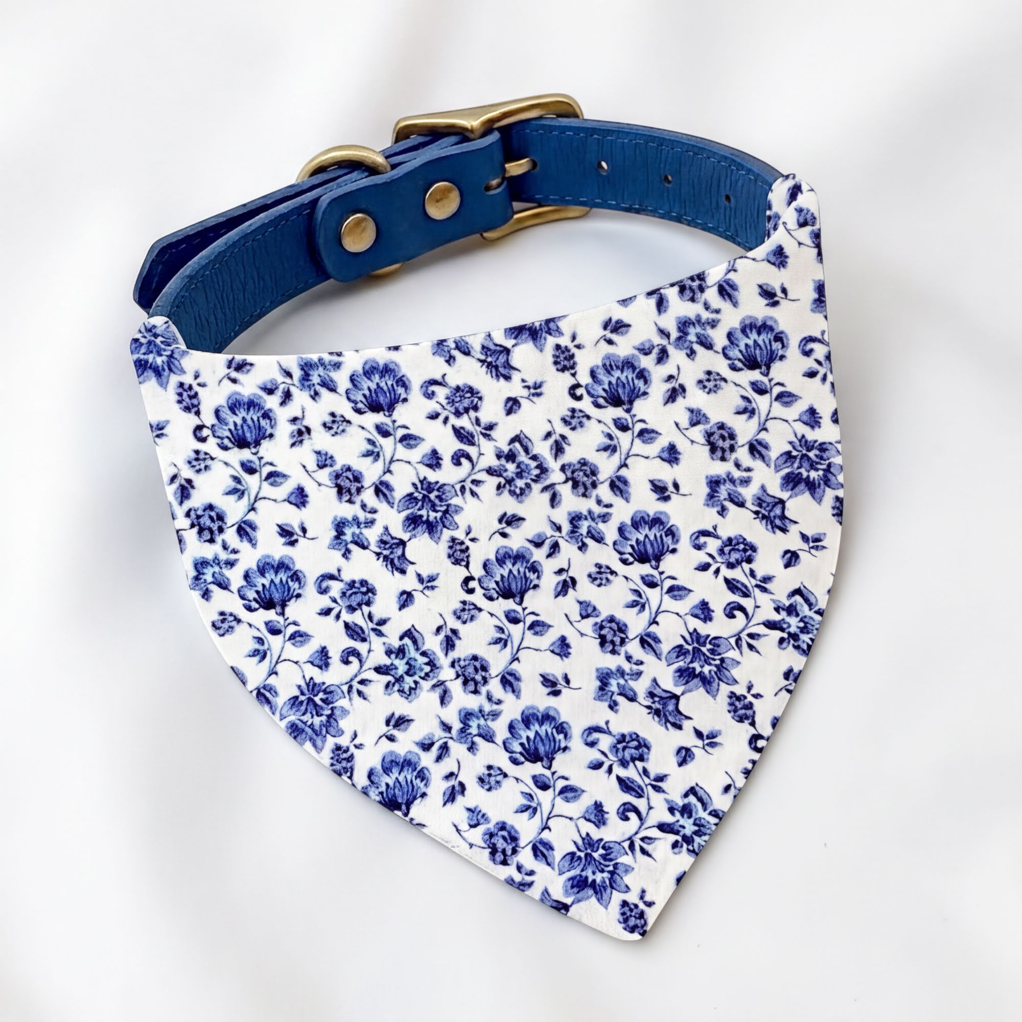 Blue floral dog bandana with a matching blue collar (sold separately) on a white background