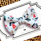 a white bow with black and red dogs on it