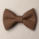Solid chocolate brown formal groomsmen bow tie isolated on a white background