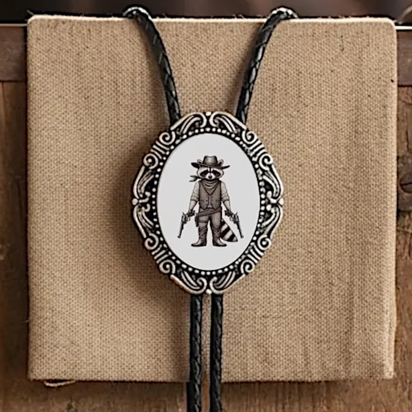 Raccoon Bolo tie with on a wooden surface