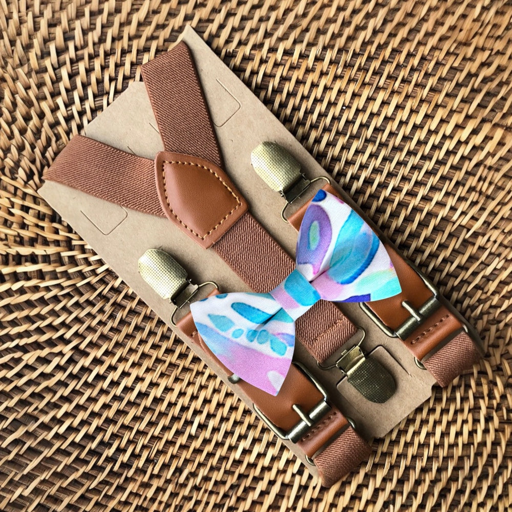 Size chart for suspender and bow tie sets from The Bold Bow Tie. X-Small (6mo-4yr): 15"-23" suspenders, 3.5" bow. Small (5-9yr): 18"-33" suspenders, 3.5" bow. Medium (10-12yr): 18"-33" suspenders, 4" bow. Adult (13yr-6'5"): 30"-53" suspenders, 4.5" bow. Big & Tall (Over 6'5"): 53"+ suspenders, 4.5" bow. Instructions note to measure from the back waistband over the shoulder to the front waistband for a comfortable fit.