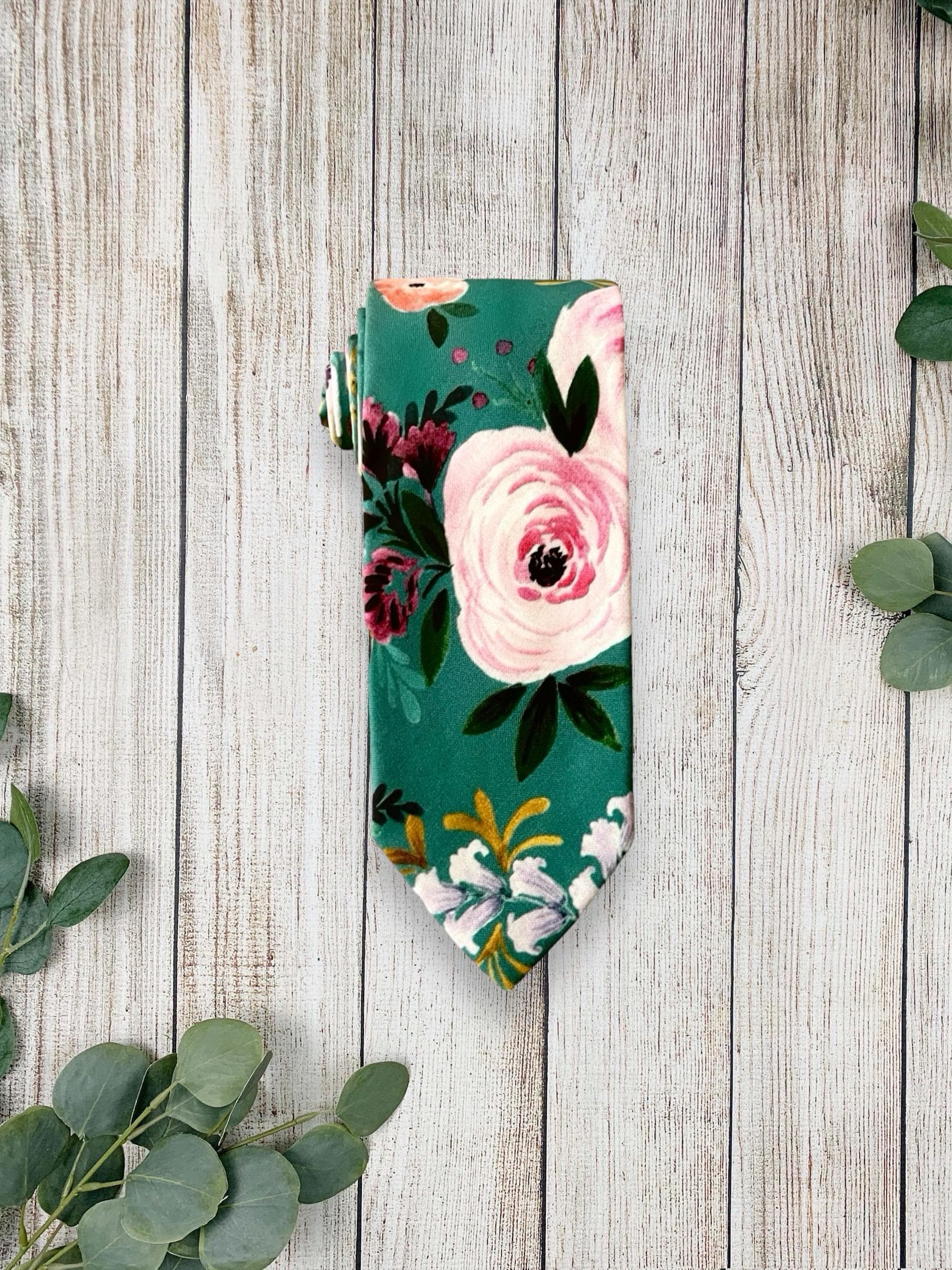 Teal floral necktie for men for wedding on a white marble counter