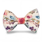 Pre-tied watercolor floral bow tie with pink roses and purple flowers on a light cream background.