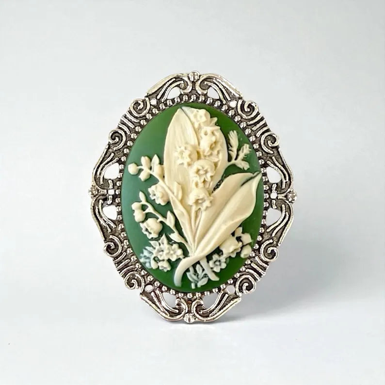 Decorative brooch with floral design on a green background