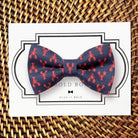 Nautical dog bow tie with navy blue and red lobsters.