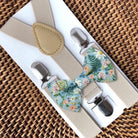 Floral bow tie and tan suspenders set for men or boys featuring floral pattern on dusty blue pre-tied bowtie with adjustable neutral elastic braces and metal clips