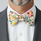 Floral bow tie worn by a man in a wedding as a groomsman.