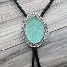 Turquoise bolo tie on a wooden surface
