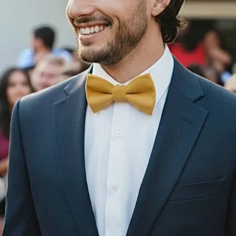 Groomsman at a wedding wearing a mustard yellow bow tie.