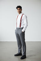 Man wearing terracotta suspenders as a groomsman in a wedding.