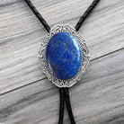Blue Stone Bolo Tie- Silver Western Wedding Accessory for Men and Women by The Bold Bow Tie On a wood background.