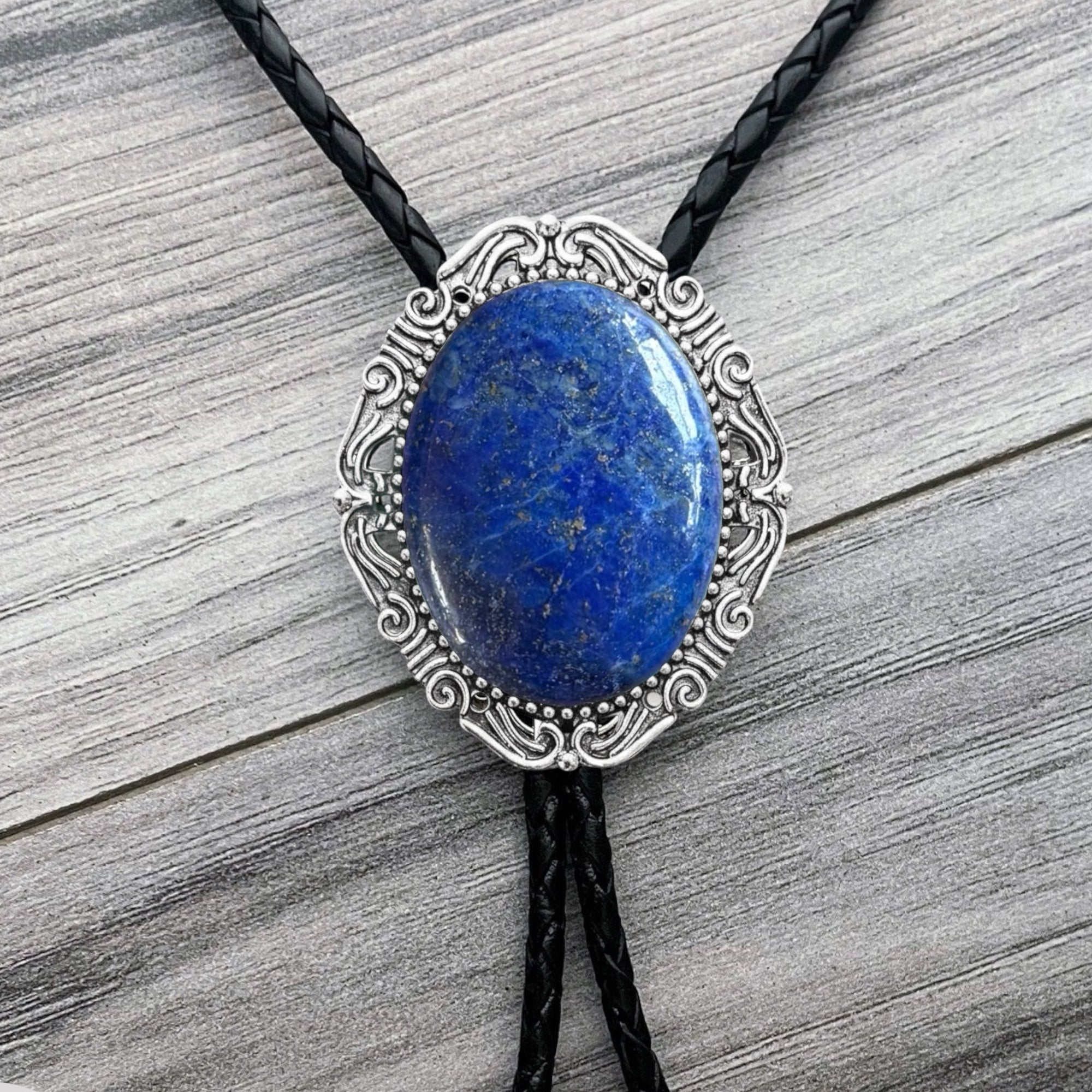 Blue Stone Bolo Tie- Silver Western Wedding Accessory for Men and Women by The Bold Bow Tie On a wood background.