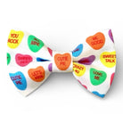 Colorful Valentine's Day bow tie with candy-themed text on a white background