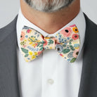 Groomsman in a floral bowtie in a wedding.