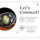 Circular belt buckle with turquoise center and intricate silver detailing on a dark background