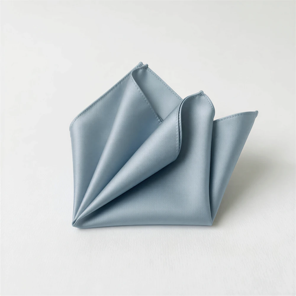 A folded light blue satin napkin is displayed against a white background.