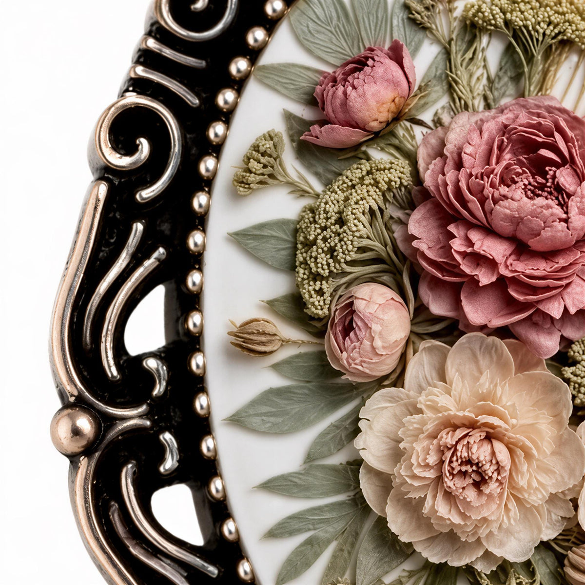 A close-up image of a decorative plate with a floral arrangement of pink and white flowers, including roses and greenery, set against a white background.