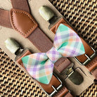 Handmade pre-tied Easter plaid bow tie paired with adjustable dark brown leather-look suspenders for a rustic holiday outfit.