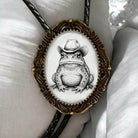 Toad bolo tie with leather cord.