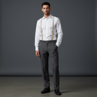 Groomsman wearing a white shirt, gray pants, and suspenders in a wedding.